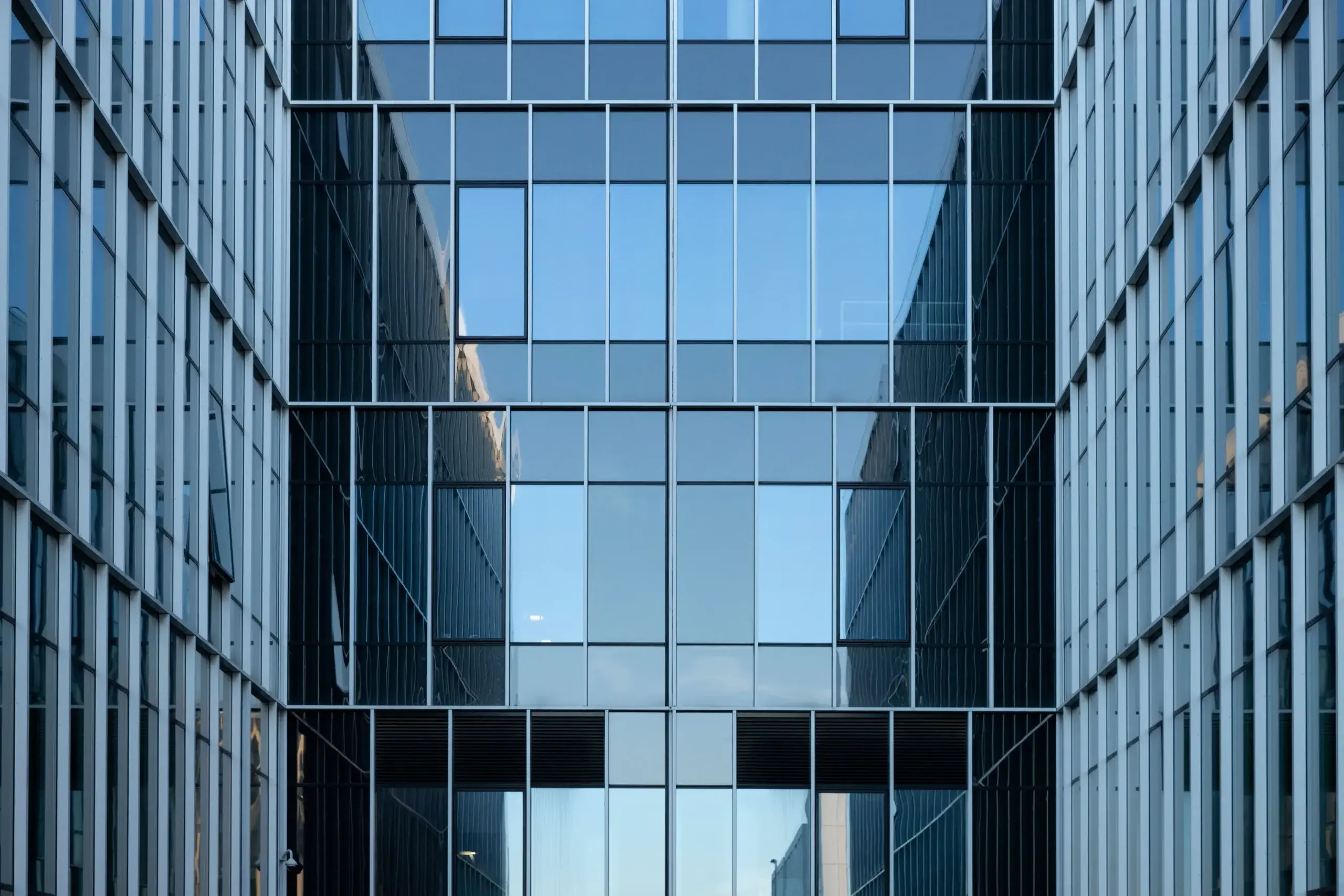 Modern corporate office building with a blue glass facade